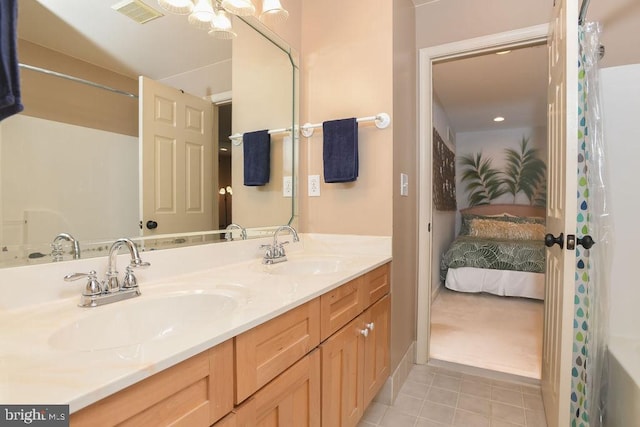 bathroom with tile patterned flooring, double vanity, visible vents, and a sink