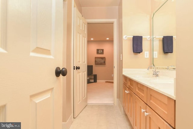 bathroom featuring a sink, baseboards, and double vanity