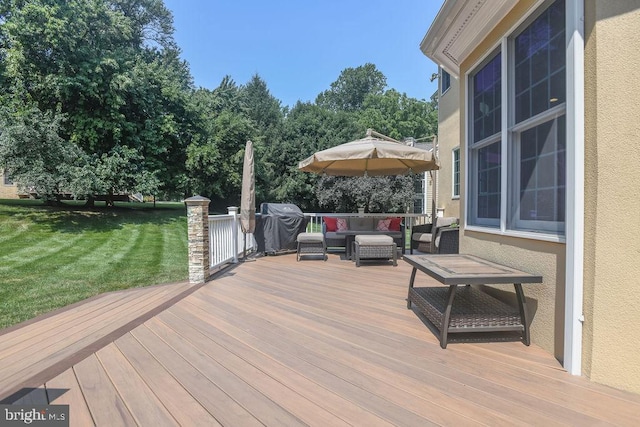 wooden terrace with grilling area, a lawn, and an outdoor hangout area