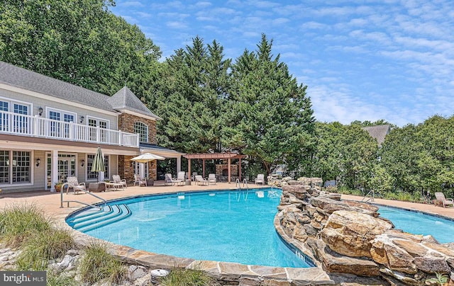 community pool featuring a patio and a pergola