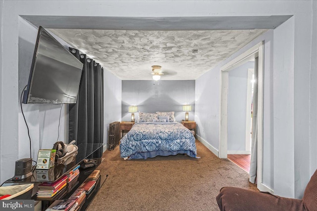 bedroom featuring a ceiling fan, baseboards, carpet floors, and a textured ceiling