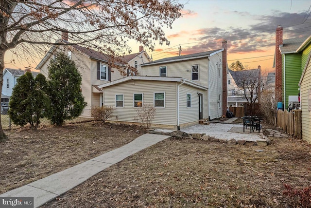 rear view of house featuring a patio and a fenced backyard