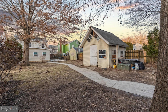 exterior space with an outdoor structure and fence