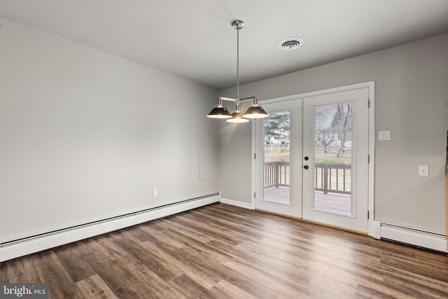 unfurnished dining area featuring visible vents, wood finished floors, baseboard heating, and a baseboard heating unit