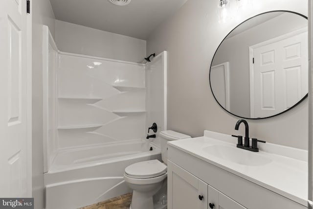 bathroom with visible vents, toilet, vanity, and shower / tub combination