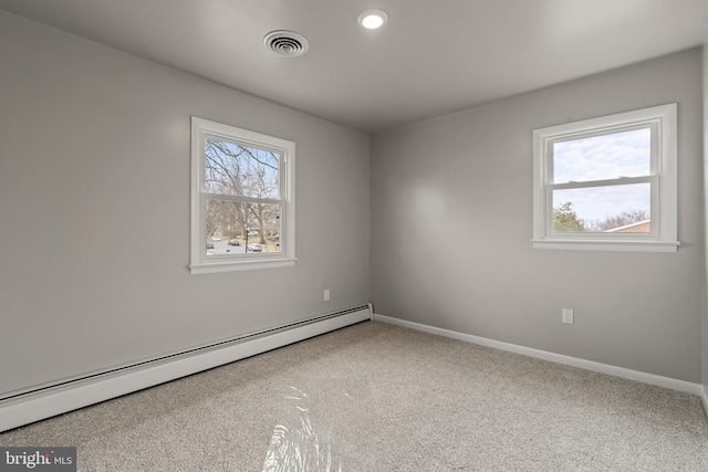 carpeted empty room with visible vents, baseboards, and a baseboard radiator