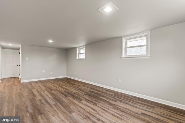 basement featuring recessed lighting, baseboards, and dark wood-style flooring