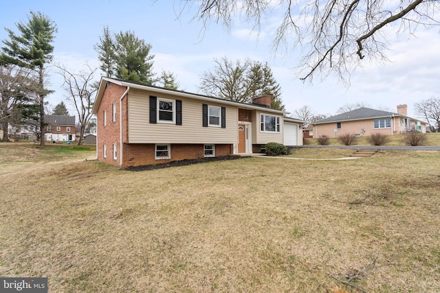 raised ranch featuring a chimney, a front yard, and a garage