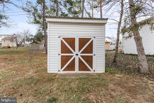 view of shed with fence