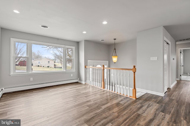 unfurnished room with visible vents, recessed lighting, baseboards, and wood finished floors