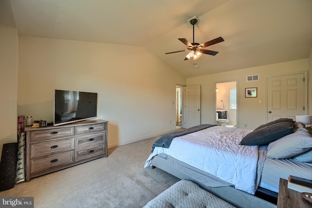 bedroom featuring visible vents, connected bathroom, baseboards, lofted ceiling, and light carpet