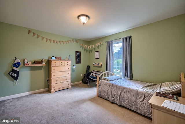 carpeted bedroom featuring baseboards