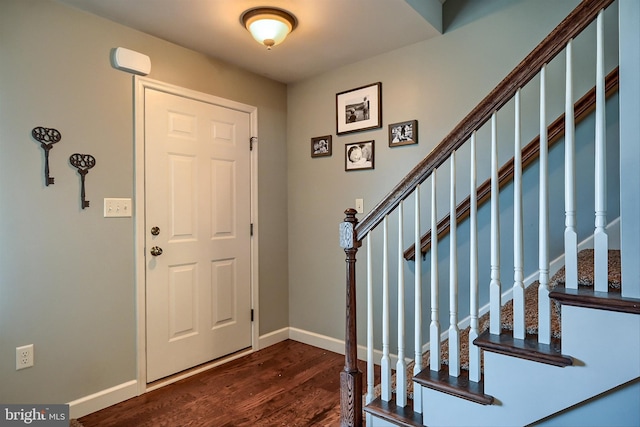 entrance foyer with stairway, baseboards, and dark wood-style flooring