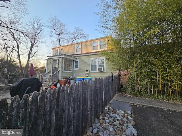 back of property featuring a fenced front yard