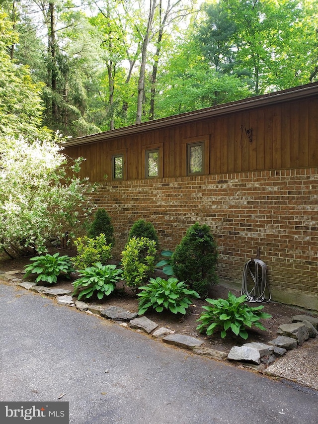 view of side of property with brick siding