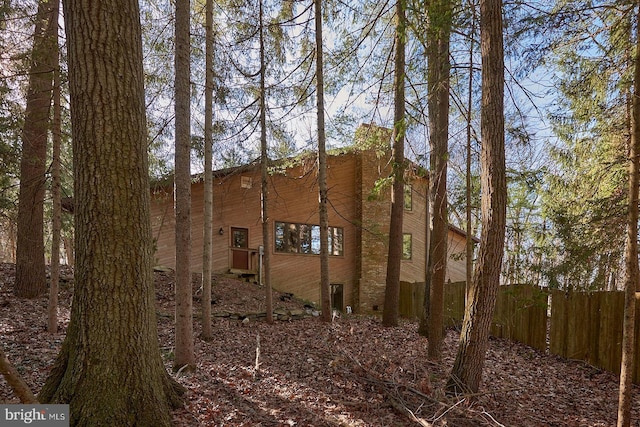 view of side of property featuring fence