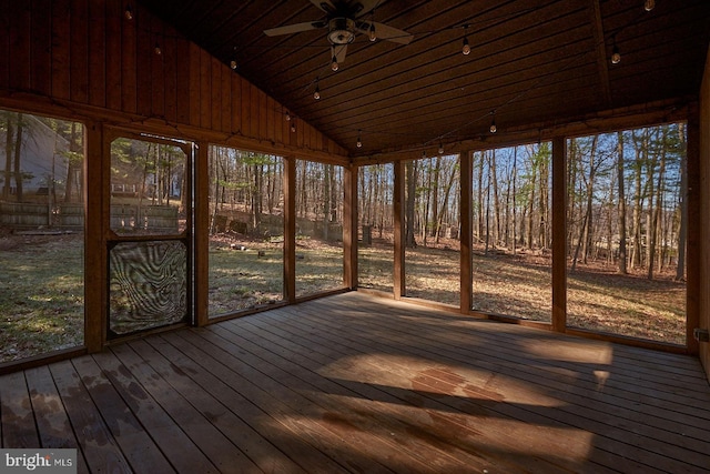 unfurnished sunroom featuring ceiling fan, track lighting, and vaulted ceiling