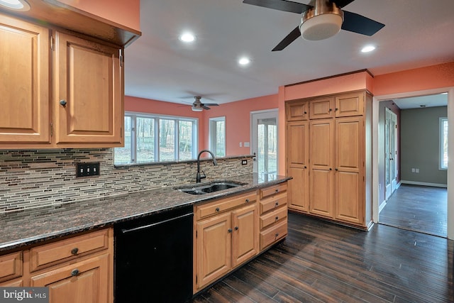 kitchen featuring a peninsula, a sink, dark wood-type flooring, black dishwasher, and backsplash