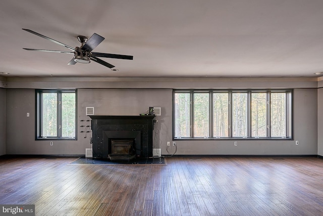 unfurnished living room featuring ceiling fan, baseboards, and wood finished floors