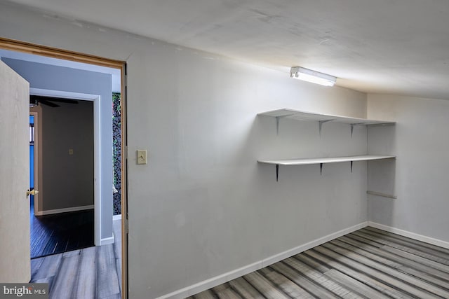 interior space featuring baseboards and wood finished floors