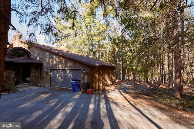 view of home's exterior with a garage and driveway