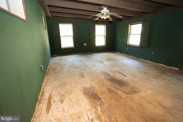 empty room with beamed ceiling and a ceiling fan