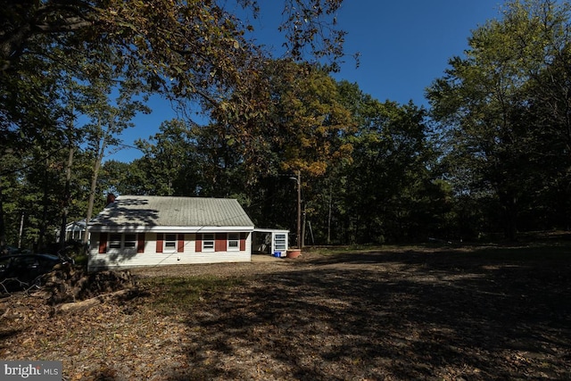 view of front of property with a view of trees