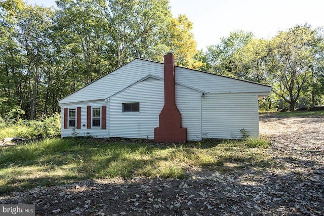 view of side of home with a chimney