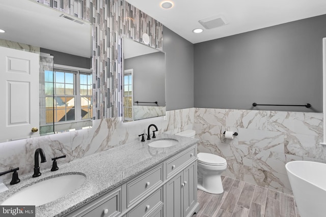 9 Quaker St, Chesterfield, NJ 08515 - bathroom with tile walls, visible vents, a sink, and a soaking tub