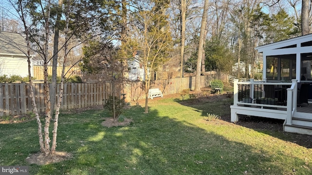 view of yard with a deck and fence