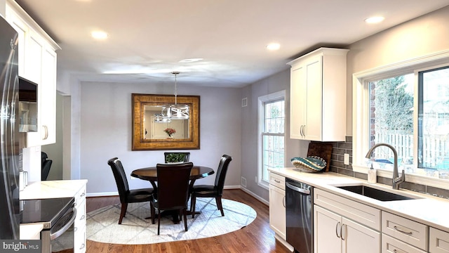 kitchen featuring a sink, light countertops, white cabinetry, and stainless steel appliances