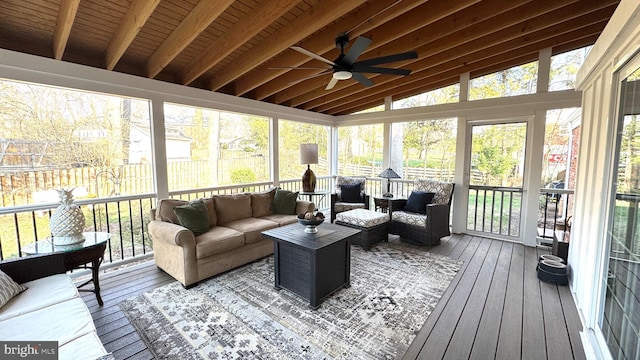 sunroom / solarium with a ceiling fan and vaulted ceiling