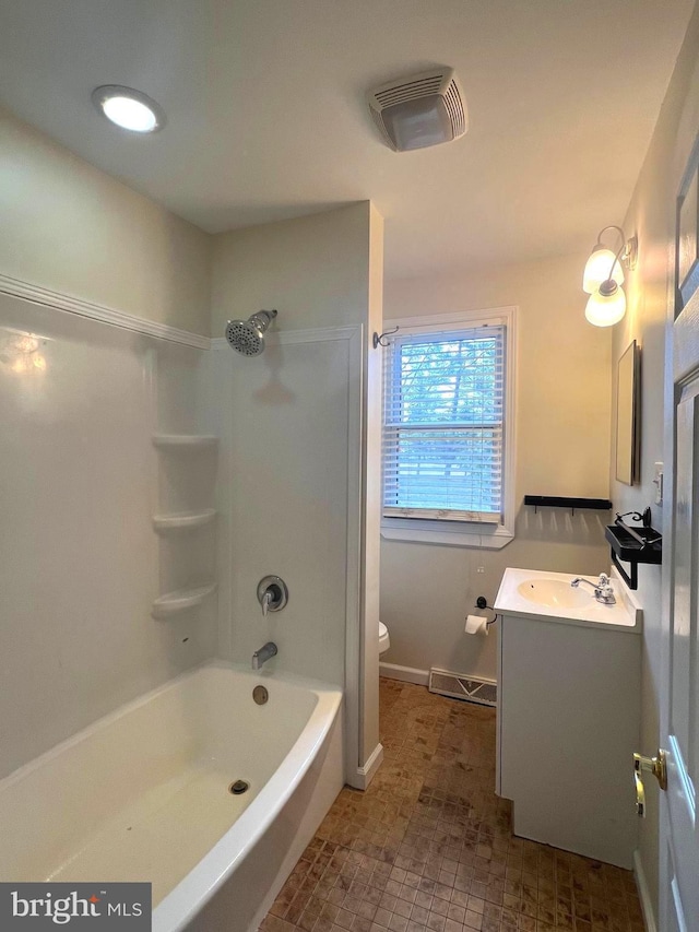 bathroom with visible vents, toilet, tub / shower combination, baseboards, and vanity