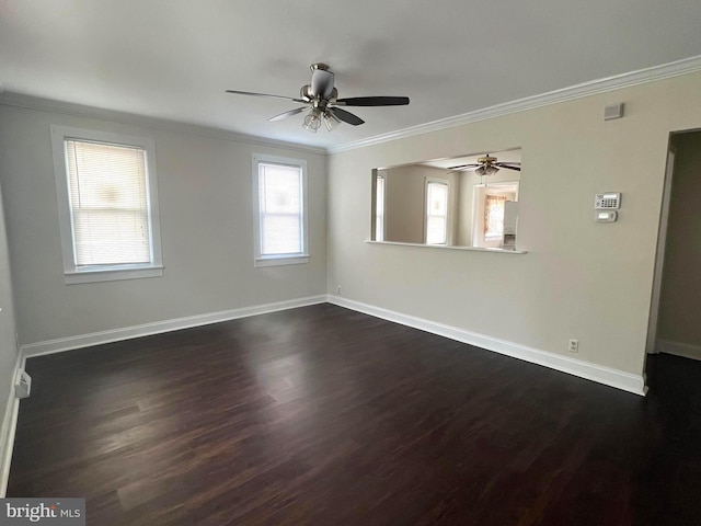 spare room featuring baseboards, a ceiling fan, dark wood-style flooring, and crown molding