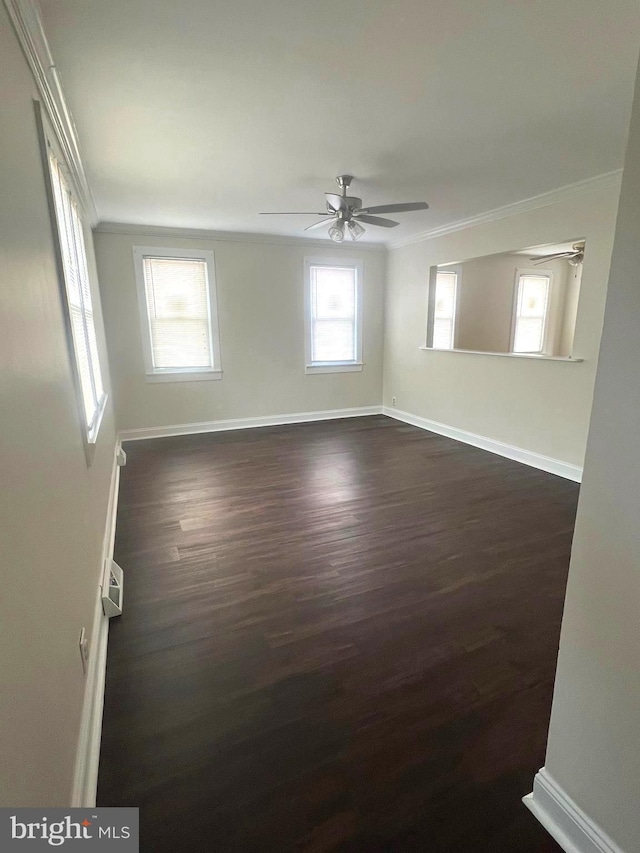 empty room featuring baseboards, a ceiling fan, and ornamental molding