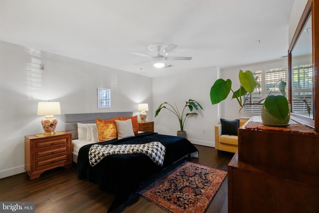 bedroom with dark wood-style floors, baseboards, and ceiling fan