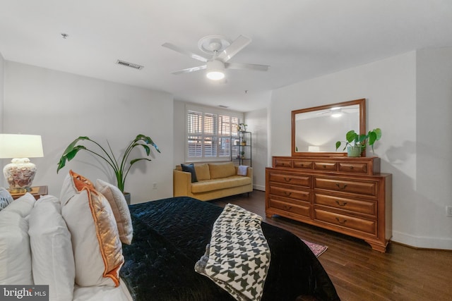 bedroom featuring visible vents, baseboards, wood finished floors, and a ceiling fan