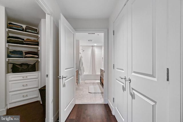 hall with dark wood-type flooring and visible vents