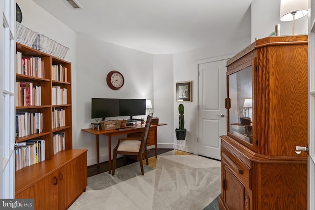 office featuring baseboards and visible vents