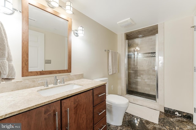 bathroom featuring visible vents, toilet, marble finish floor, a stall shower, and vanity