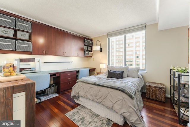 bedroom featuring dark wood-style floors, built in desk, and crown molding