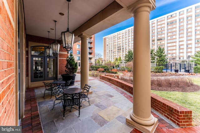 view of patio featuring french doors and fence