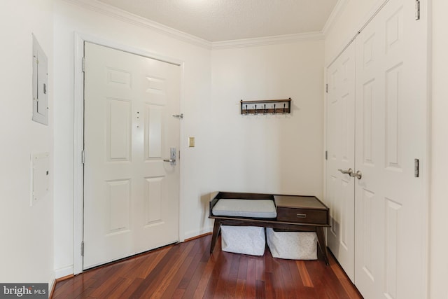 foyer entrance with electric panel, baseboards, dark wood-type flooring, and crown molding