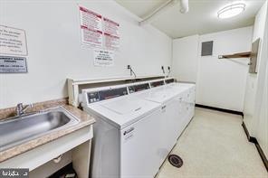 community laundry room featuring a sink and washing machine and dryer