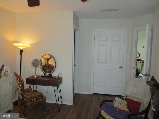 interior space featuring a ceiling fan, wood finished floors, visible vents, and baseboards