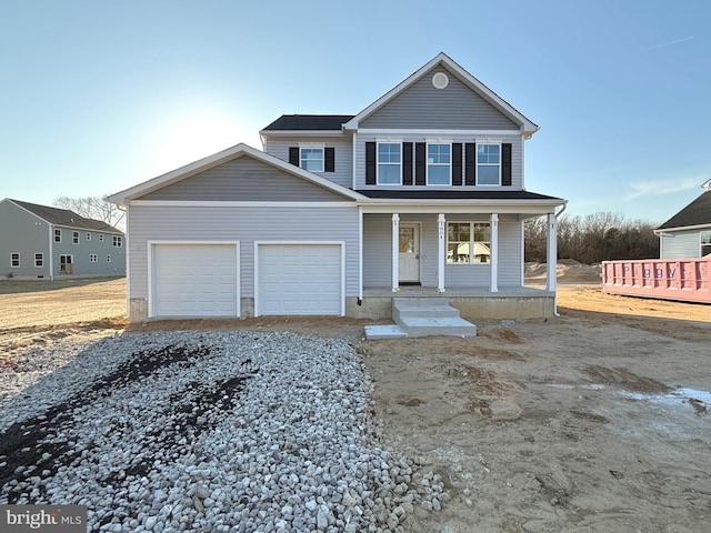 traditional-style home with gravel driveway, a porch, and a garage