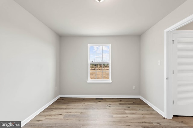 empty room featuring baseboards and wood finished floors