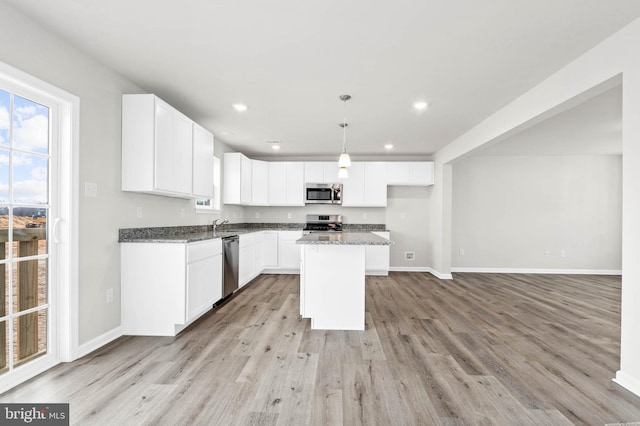 kitchen with white cabinetry, baseboards, light wood-type flooring, and appliances with stainless steel finishes