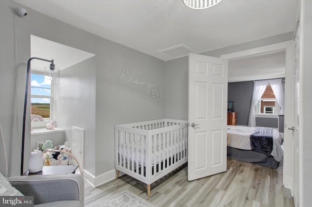 bedroom with baseboards and wood finished floors