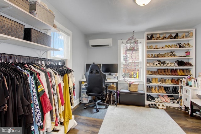 home office featuring dark wood finished floors and an AC wall unit